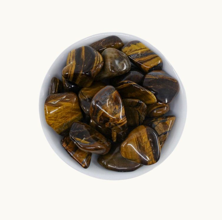 "Tumbled Tiger's Eye Crystals: Stone of balance, vitality, and practicality. Enhances mental clarity and strength to overcome fatigue, fear, and discouragement. Pairs well with Malachite. Chakras: Root, Sacral, Solar Plexus. Physical benefits: Blood fortifier."